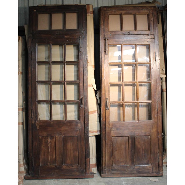 Our teak door has a transom top, a unique one-of-a-kind piece. This is an amazing door with great hardware & and unusual...