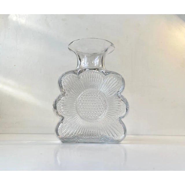 Clear glass vase with sunflower motif to both sides. Its called Amuletti Kinkas and was designed by Tamara Aladin and...