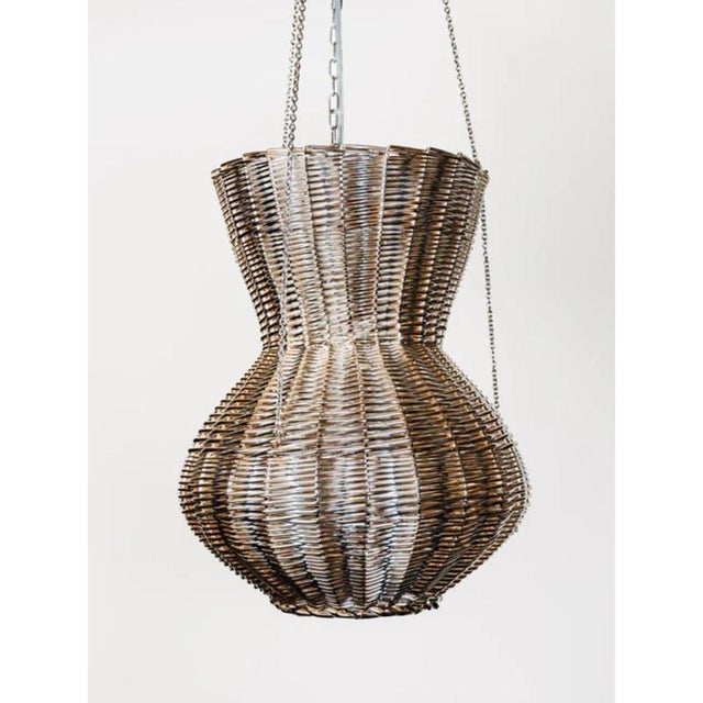 Oman chandelier in metal-plated hand-woven wicker by caspal dimensions: ø 32 x h 104 cm. Materials: metal-plated wicker....