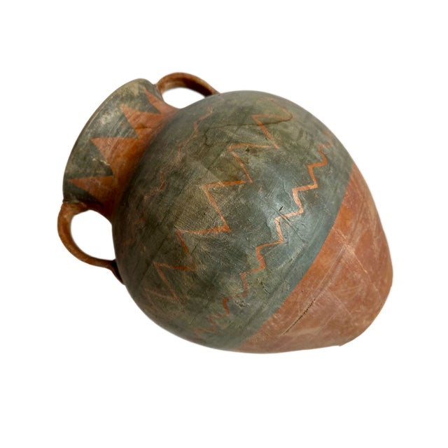 This hand painted pottery has beautiful pattern and balanced curve shape. Two strap handles attached to the neck add...