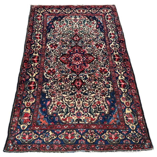 A fabulous antique Bakhtiar rug, woven circa 1920. The design features a small terracotta medallion on an unusual ivory...