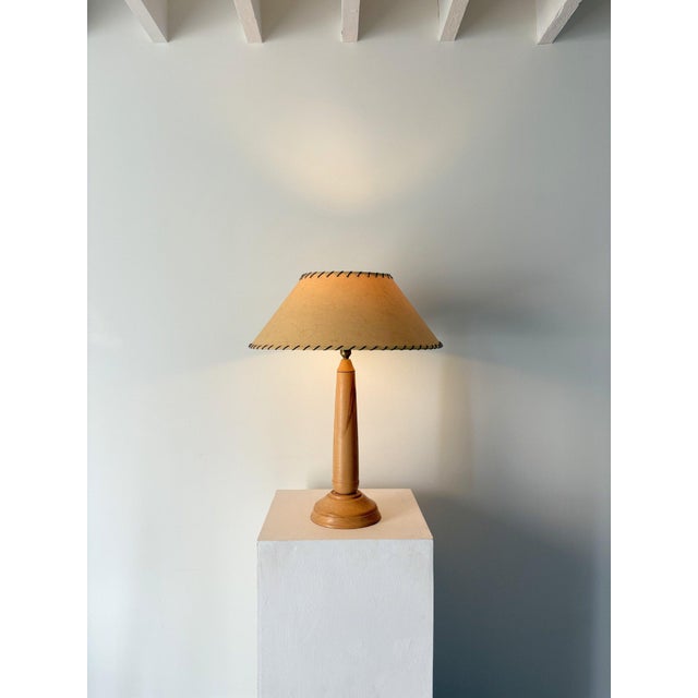 A sleek Mid Century table lamp comprised of beautifully turned beech wood. This vintage accent light has a heavy set...