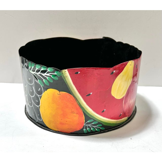 A vibrant vintage toleware cachepot hand-painted with oversized fruit, foliage, and bold blocks of red, yellow, green, and...