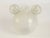 - White opalescent glass container - Attached ears under the rim of a nude female figure inside a circular garland of...