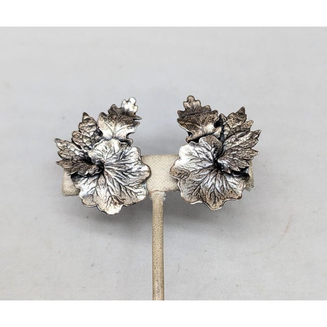 1950s silvertone overlapping leaves of oak, maple and water lily butterfly clip back earrings. Marked "NAPIER PAT. PEND."...