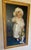 A beautifully executed late 19th-century oil portrait depicting a young girl in a white bonnet, presented in its...