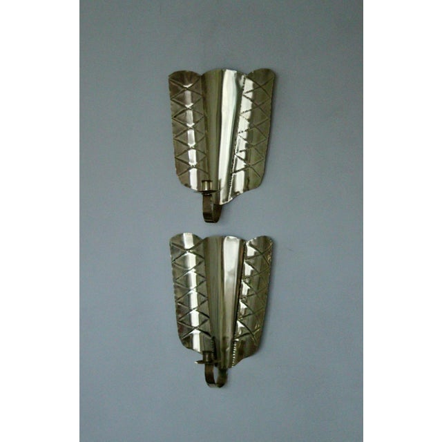 Pair of Mid-Century Swedish Brass Shield Shape Sconces Striking Swedish mid-century brass wall sconces with a bold shield-...