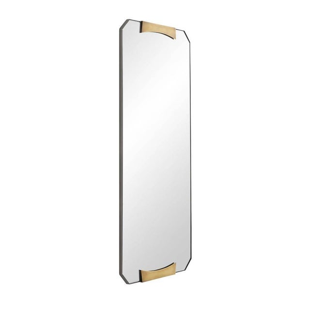 Elegantly modern, the Kris Rectangular Mirror displays a refined geometric design. Gracefully formed brass clasps hold...