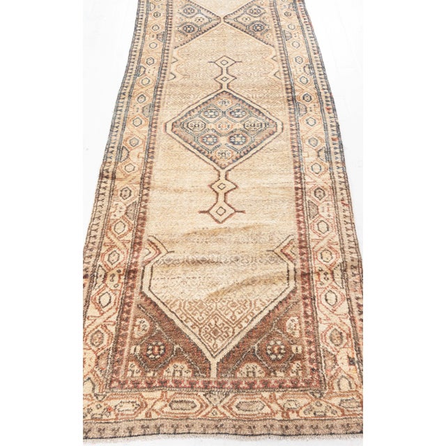 This late 19th century antique Persian Sarab runner is a stunning presentation of classic Oriental motifs on a field of...
