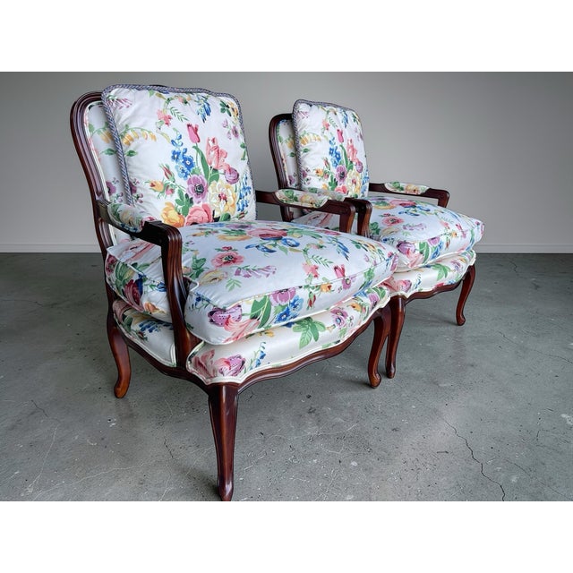 Elegant pair of Louis XV style bergère armchairs by Century Furniture featuring carved mahogany frames with graceful...