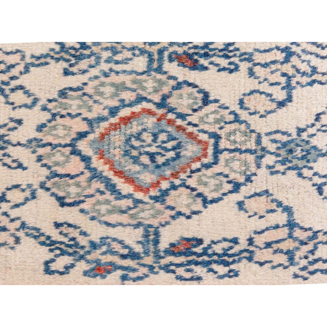 An early 20th century antique Persian Malayer rug, the midnight blue field with a lush flowering vinery overall around...