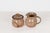 A 1988 vintage hand-thrown red stoneware creamer and lidded sugar bowl set, featuring a tan glaze with brown wheat motifs....