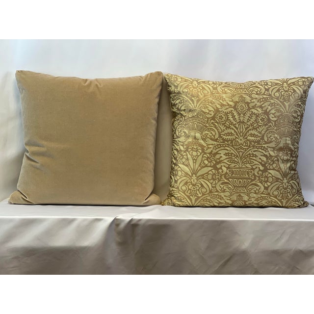 Custom-tailored 22” square knife edge pillows in Mariano Fortuny “Campanelle” seafoam green and silvery gold fabric. Light...