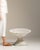 Painted pedestal bowl planter in Weathered Antique White. The weathered antique white surface highlights flared bowl form,...