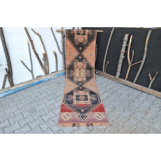 This spectacular Turkish long runner rug was handmade in Anatolian lands in the mid 20th century. This Vintage Oushak...
