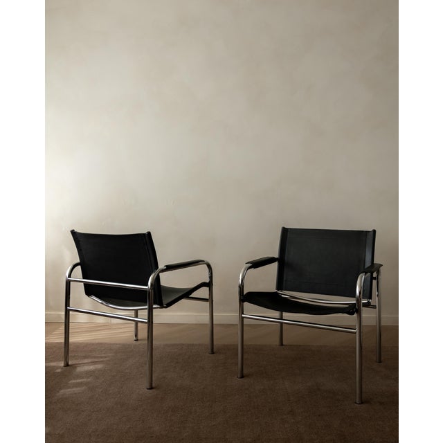 A vintage pair of klinte lounge chairs in chrome-plated tubular steel and black leather, designed by tord björklund for...