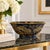 Elegant decorative bowl featuring a rich navy blue ground with an intricate gilt chinoiserie design depicting quail,...