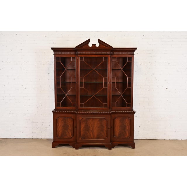 A gorgeous Georgian or Chippendale style lighted breakfront bookcase cabinet or dining cabinet By Baker Furniture,...