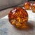 Bring warmth and sculptural elegance to a bookshelf, coffee table, or console with this striking set of three amber art...