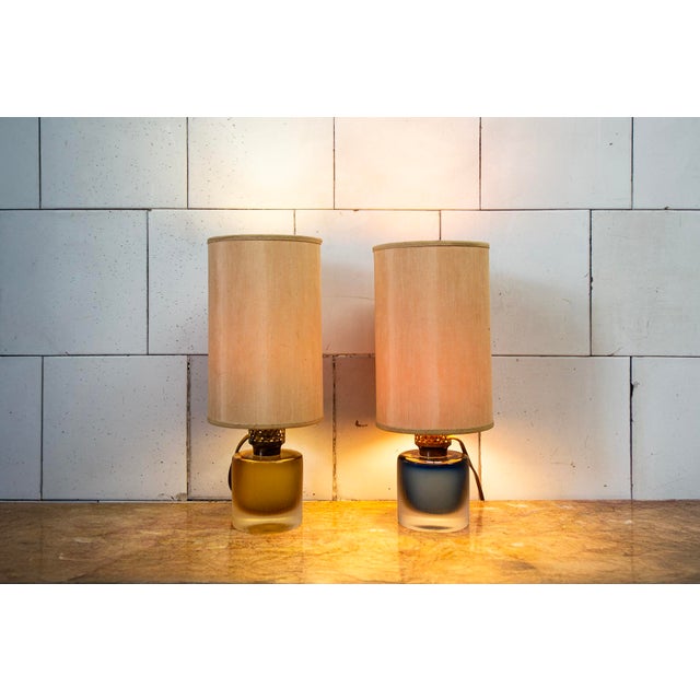 Pair of table lamps with engraved Murano glass bases, brass frames, and fabric lampshades. Manufacturer: Venini 1960s I...