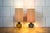Pair of table lamps with engraved Murano glass bases, brass frames, and fabric lampshades. Manufacturer: Venini 1960s I...