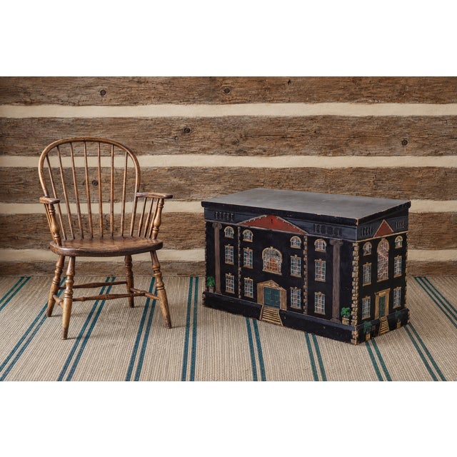 A charming English country folk art painted pine trunk or blanket chest, hand-decorated with a weathered architectural...