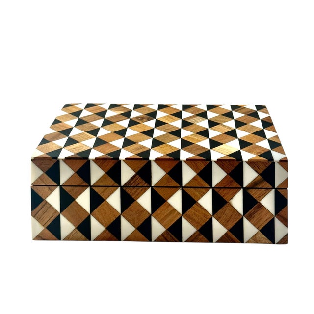 A beautifully crafted decorative box featuring a striking geometric inlay of bone, ebony, and various fine woods. The...