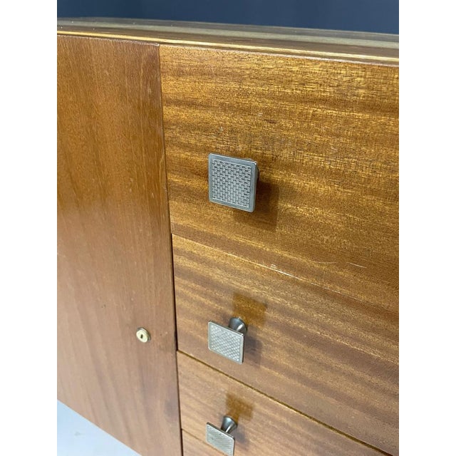 A stylish sideboard from the 1970s, made in former Czechoslovakia. The all-wood construction is supported by metal legs,...