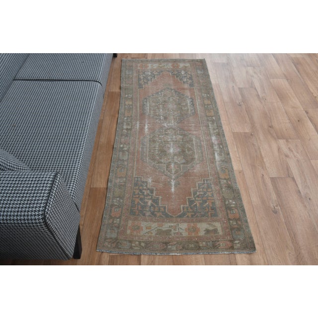 Vintage Hand-Knotted runner rug is a semi-antique vintage area rug. The '70s Eastern region of Anatolia's unique rug is...