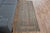 Vintage Hand-Knotted runner rug is a semi-antique vintage area rug. The '70s Eastern region of Anatolia's unique rug is...