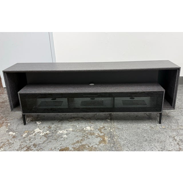 Design Plus Gallery presents the Cavo Model 8167 Home Theater Cabinet from BDI. The rectangular case displays a graphite-...