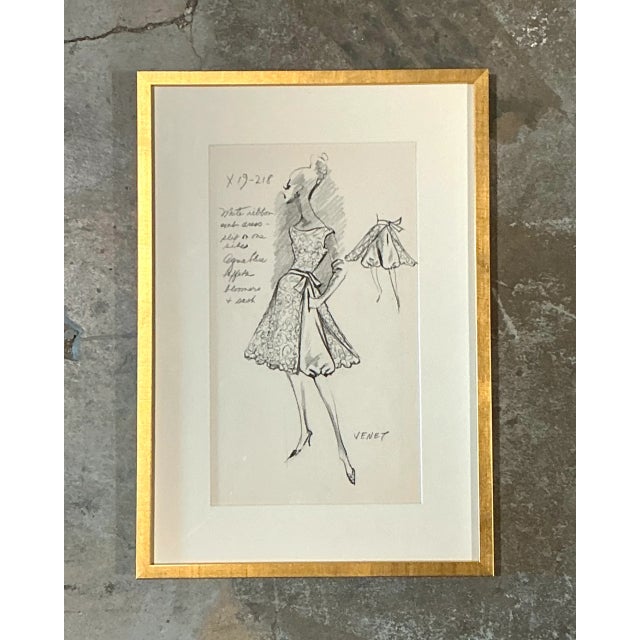 This vintage framed fashion illustration by Philippe Venet captures the elegance of mid-20th-century haute couture....