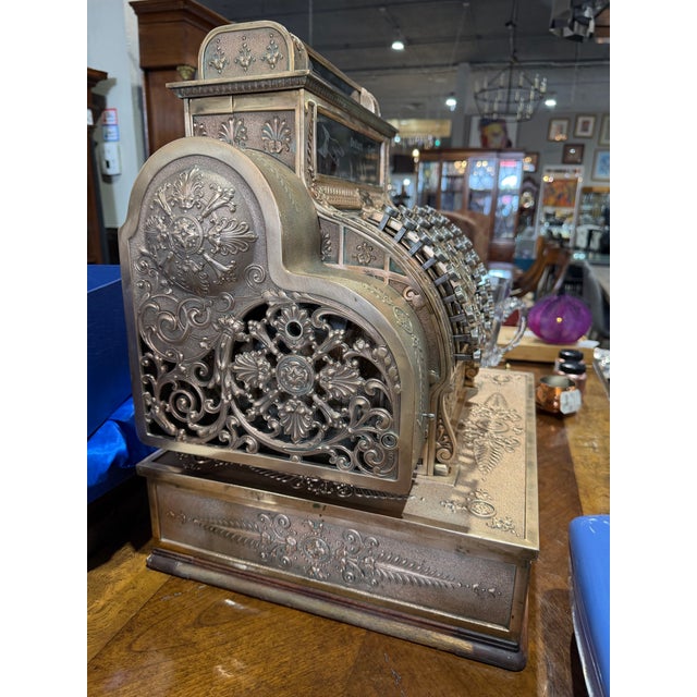 A true icon of American industrial craftsmanship, this antique National Cash Register Co. Model 441 is a stunning example...