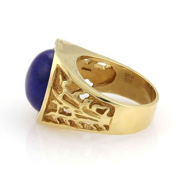 This handsome vintage 18k yellow gold ring features a bold and artistic open design. The center showcases a striking round...