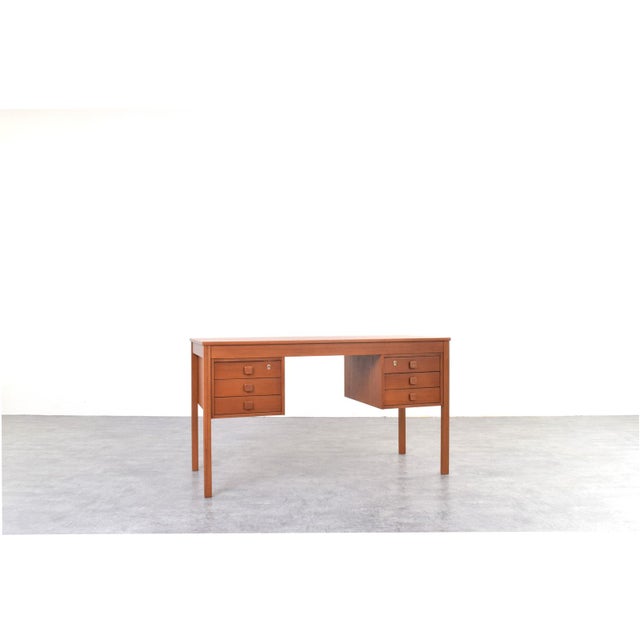 This Danish desk from the 1960s, manufactured by Domino Møbler, represents a typical approach to furniture design in the...