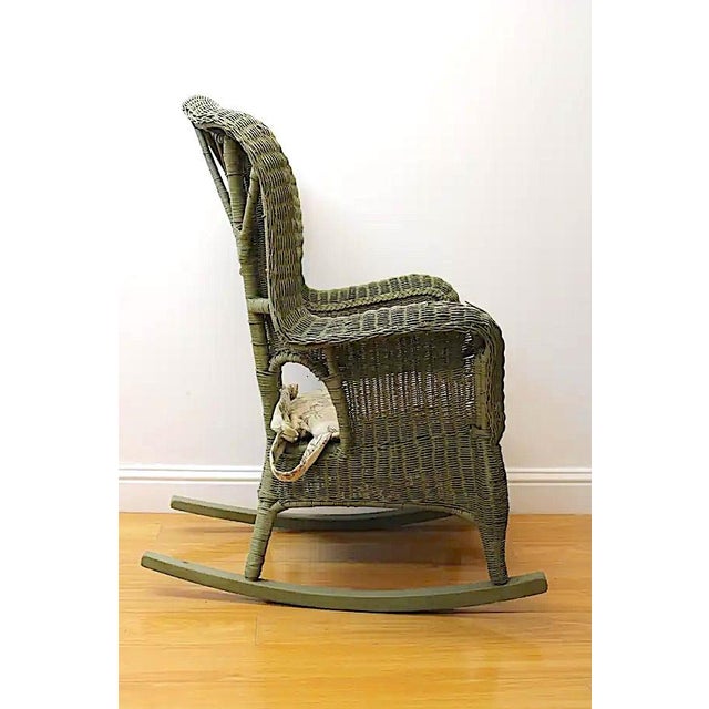 Adorable green Victorian wicker rocking chair w/ cushion. Fresh paint plus cushion can lead to relaxing fireside- or...