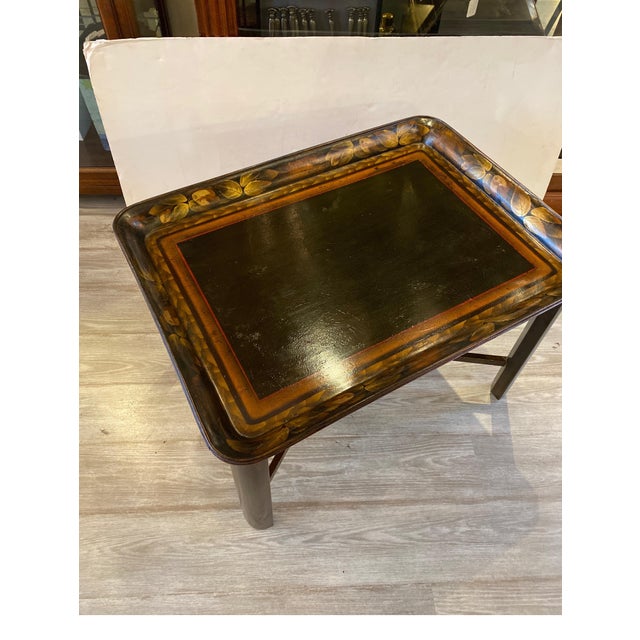 A circa 1870's Papier Mache had gilt and decorated tray with a later custom dark wood base. The tray table with the tray...