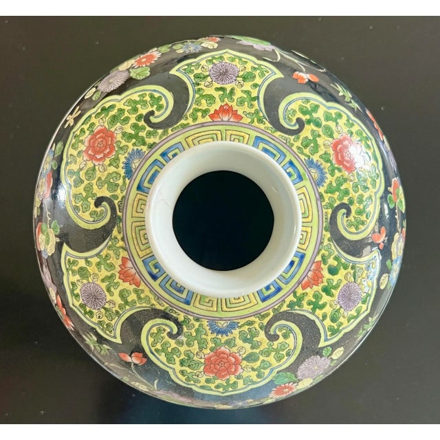 A large Chinese Meiping shaped vase that is finely hand painted in enamels in the Kangxi style. An interesting palette of...