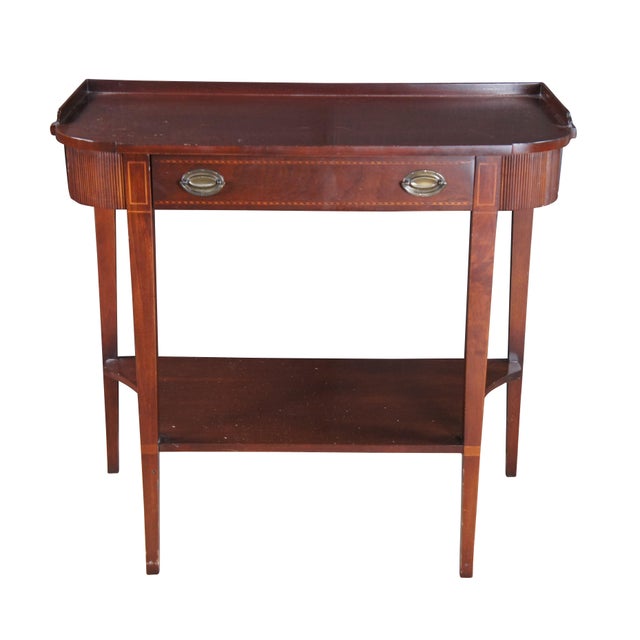 Mersman English Regency Style Mahogany Console table, circa 1960s. Features a Demilune top over a frieze drawer with...