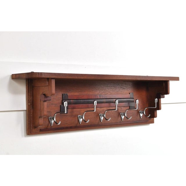 Beautiful wall coat rack from the 1930s in Art Deco style. The oak coat rack has 5 double hooks and a hat shelf....