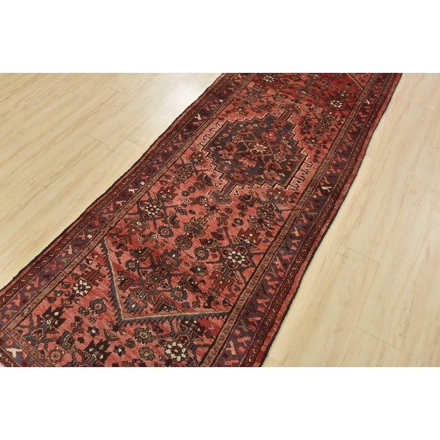 An authentic vintage tribal Hamedan runner hand-knotted with fine wool and natural dyes. This nomadic oriental rug...