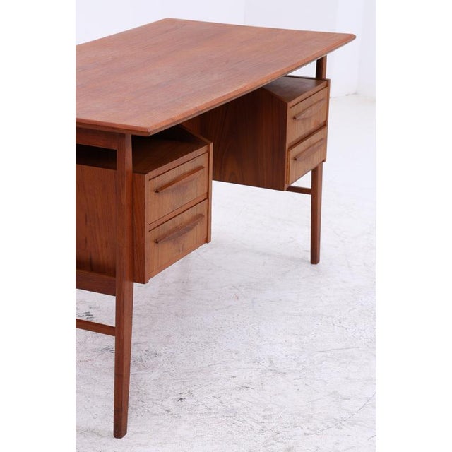 Vintage desk by Gunner Nielsen for Tibergaard from the 1960s with clean lines and a warm teak finish. The practical layout...
