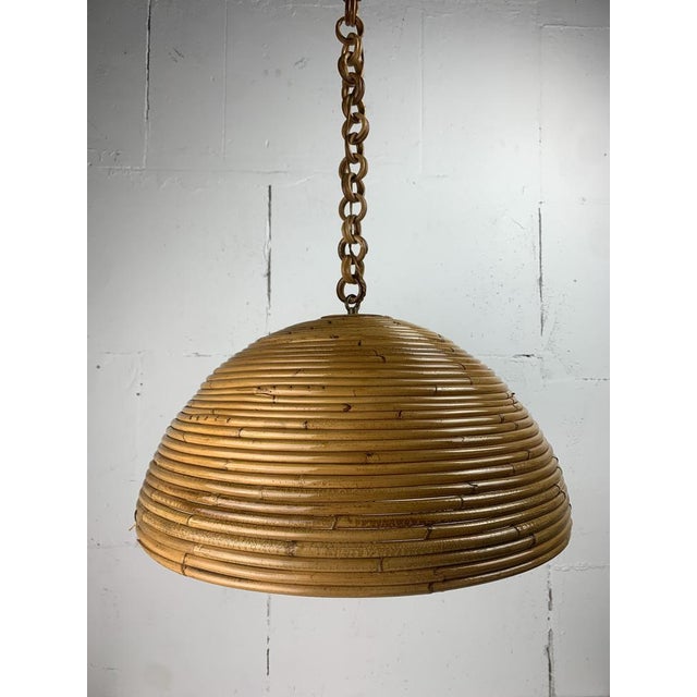 A wonderful pencil or split reed rattan wicker bamboo pendant lamp, Italy 1970s. The split reed is still in great...