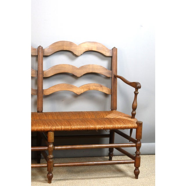 Large 19th-century walnut bench with a straw seat. Very good condition. DIMENSIONS: 1.97m long, 0.50m deep, 0.97m high....
