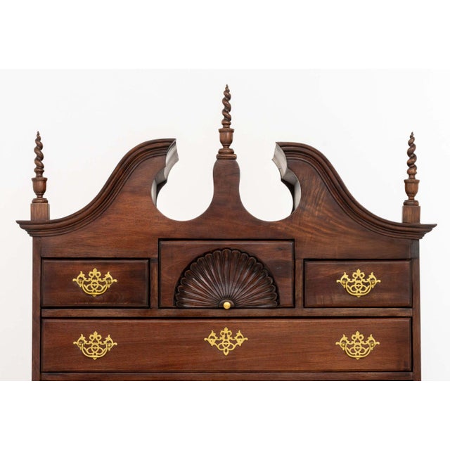 Queen Anne Style Mahogany Highboy, the top portion with three short drawers above four frieze drawers and the lower...