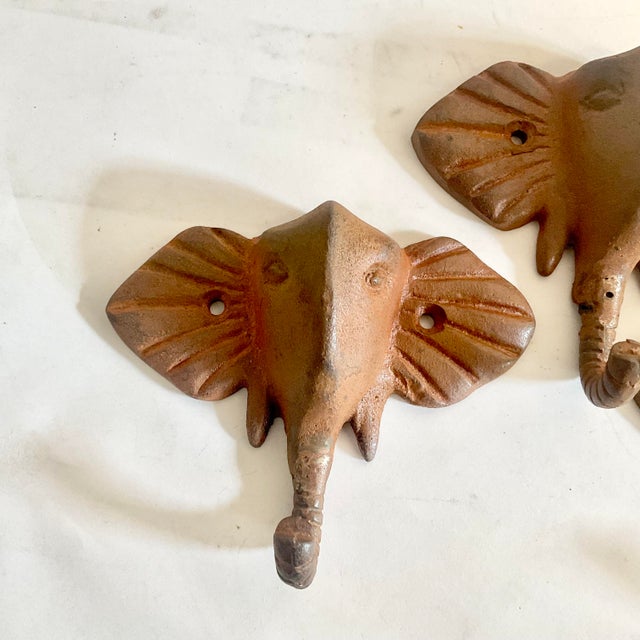 These are a set of 3 Cast Iron Elephant Wall Hooks. They have a Chestnut primer finish and are in a Trompe L’Oeil style....