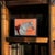 A striking mid-century reverse-painted glass portrait of a white horse, executed in an expressive folk art style and...