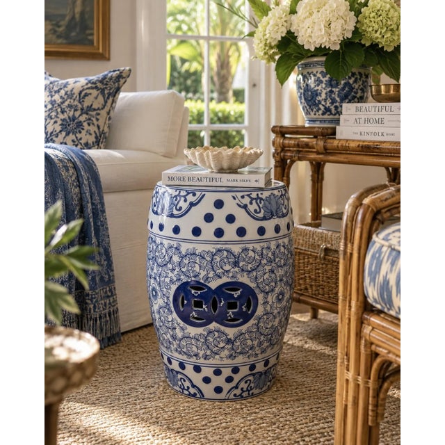 A classic blue and white porcelain garden stool, decorated with traditional Chinese motifs and stylized floral elements....