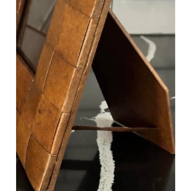 1960s leather-wrapped frame with a tessellated modernist surface. The dimensional grid of leather panels lends the piece...