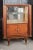 French Art Deco Cherrywood vitrine by Jules Leleu (1883-1961) from the 1930s and features a top compartment with two...